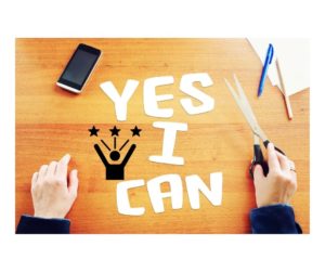 Yes I Can written in white on desk with mobile phone and hands